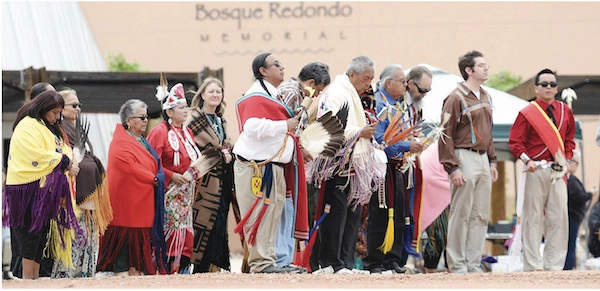 Gourd Dancers 2016 A line of Navajo and Kiowa participants in traditional regalia in front of the Bosque Redondo Memorial during a commemorative ceremony.