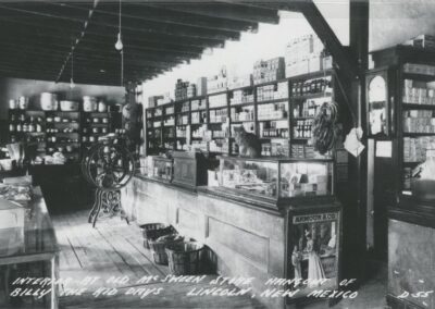 Vintage general store interior with a long counter and glass display cases.