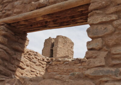 Ancient stone ruins frame a crumbling tower in the distance.