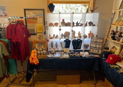 Jewelry display and clothing at a craft fair booth.