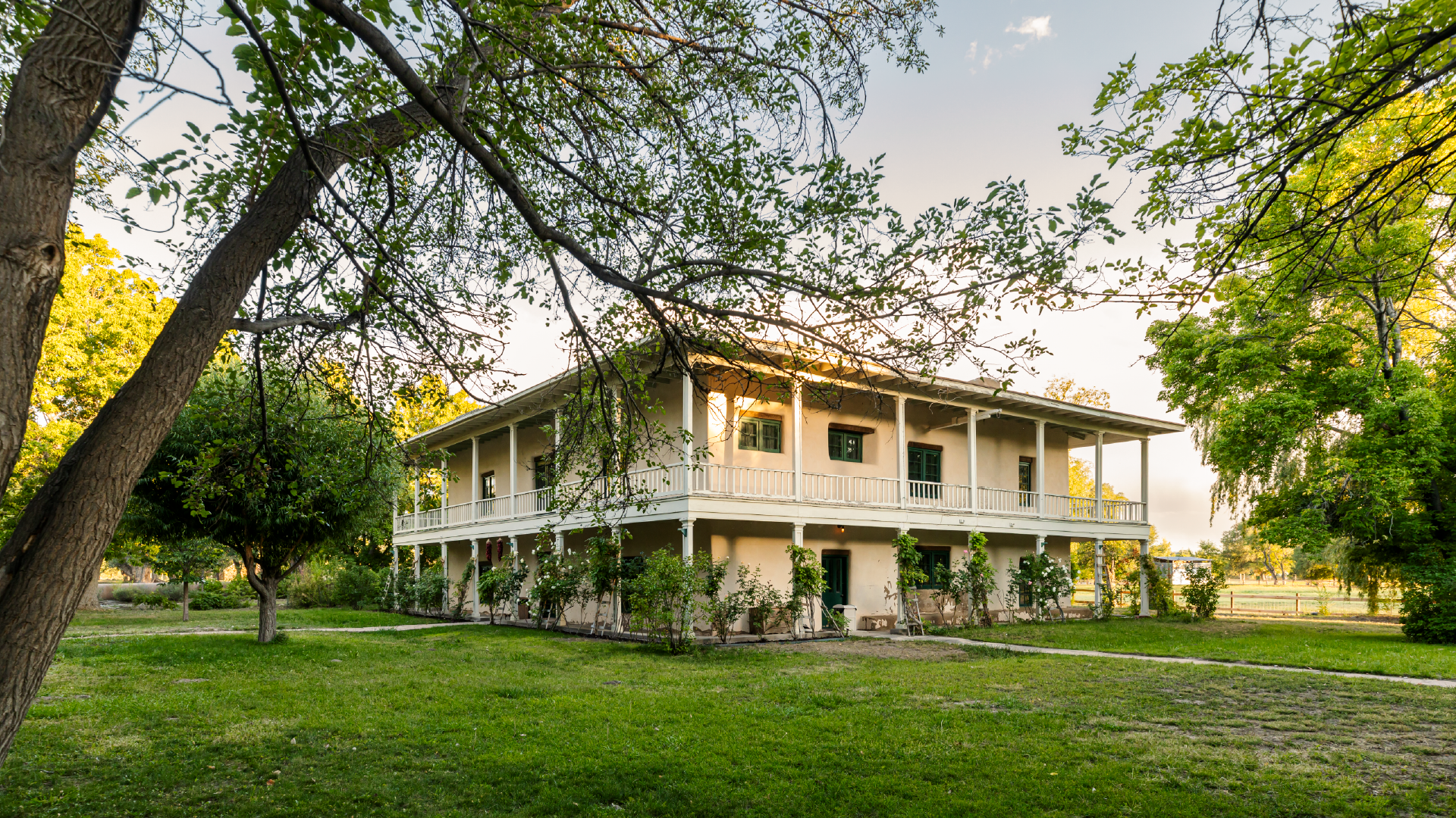 16 x 9 Historic Sites-07 Sheep grazing in grassy area next to large ranch style home